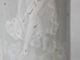 a white vase with a picture of a woman on it