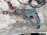 a picture of a drill and a corded cord on a concrete slab