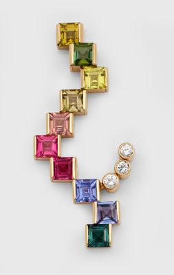 a close up of a multicolored necklace on a white surface