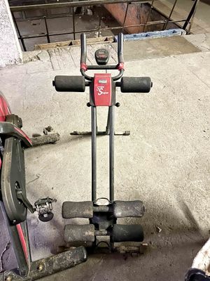 a red and black exercise bike and a black and white dog
