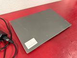 a laptop that is sitting on a table with a charger