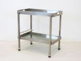 stainless steel serving cart with glass shelves on casteors