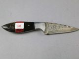 a knife with a tag on it sitting on a table