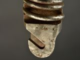 a close up of a metal object with a screw on it