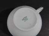 a close up of a cup and saucer on a table