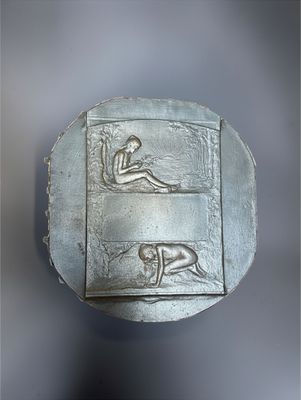 an image of a metal object with a man and a woman on it