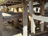a wooden table and benches that are outside
