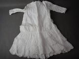 a white dress that is laying on a table