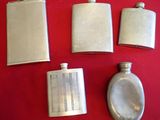 four flasks and a spoon on a red surface