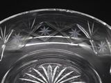 a clear glass bowl with a star design on it
