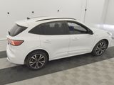 the rear end of a white car parked in a garage