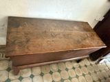 a wooden table with a drawer underneath it on a tiled floor