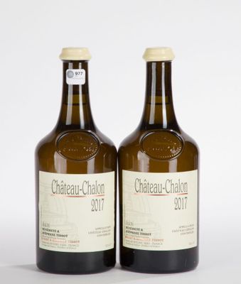 two bottles of wine are sitting next to each other on a white surface