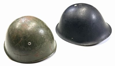 two helmets sitting next to each other on a white surface
