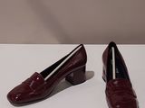 the woman ' s shoes are sitting on a white surface