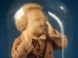 a doll in a clochet on a blue background