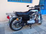 a motorcycle parked on the sidewalk in front of a building