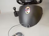 a steering wheel and a cable connected to a car