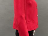 a mannequin wearing a red jacket and black pants