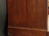 a wooden cabinet with a clock on top of it