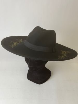 a black hat with a black band on top of a mannequin head