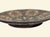 a brown bowl sitting on top of a wooden stand