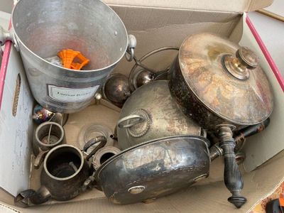 many pots and pans in a box on the floor