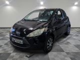 a picture of a small black car parked in a garage