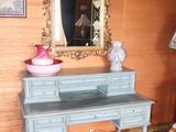 a blue desk with a mirror on it in a room