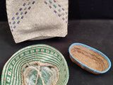 two baskets and a bag are sitting on a table