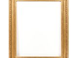a gold frame on a white wall with a white background