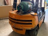 a forklift truck that is parked in a garage