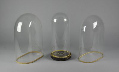 three clear glass vases with gold trims and a clock inside