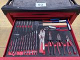 many tools in a red tool box on the ground