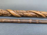 an image of a wooden stick with a carved handle and a cane handle