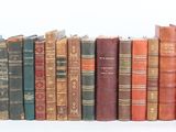 a lot of books that are stacked on top of each other