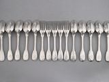 a lot of silver spoons and forks on the table