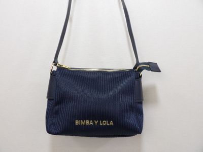 a small blue purse with a gold logo on it