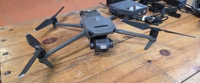 a small black drone sitting on a wooden table