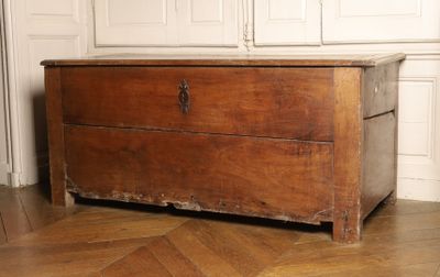 a wooden chest sitting on the floor in a room