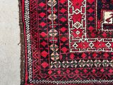 a red and black rug with a pattern on it