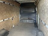 the inside of a van with the door open and a mattress in the back