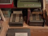 a lot of old typewriters on display in a room
