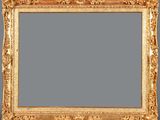 an ornate gold frame with a gray background