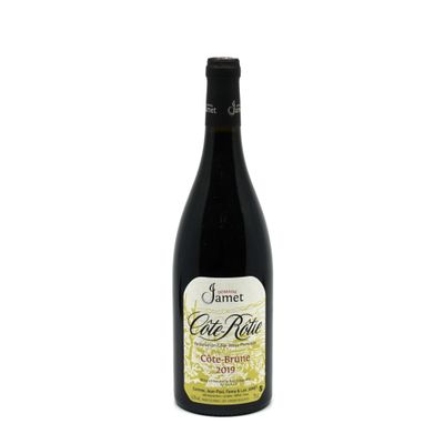 a bottle of wine sitting on top of a white table