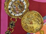 a colorful scarf with a gold pocket watch on it