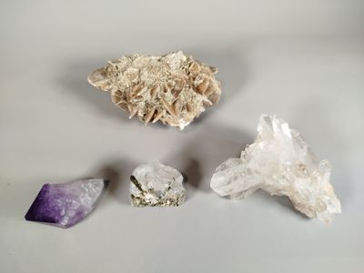 three different types of crystals are displayed on a white surface