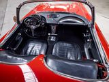 a red sports car with black leather seats and a steering wheel