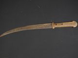a knife with a wooden handle sitting on top of a table