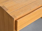 a close up of a wooden table with a drawer on it
